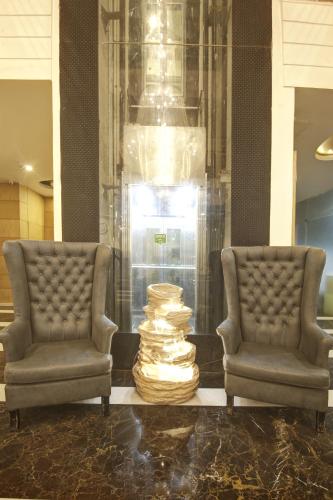 two chairs and a stack of books in a lobby at Hotel All Iz Well - Traveller Choice Award winner 2025 in New Delhi