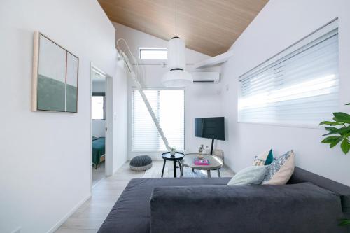 a living room with a bed and a table at ぷふか東向島2 in Tokyo