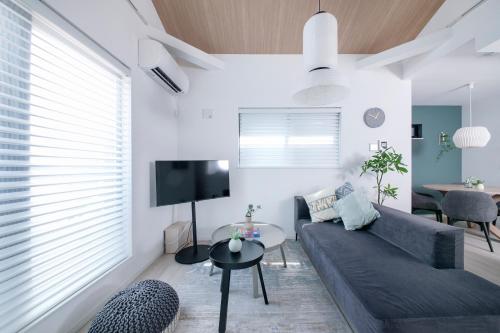 a living room with a couch and a table at ぷふか東向島2 in Tokyo