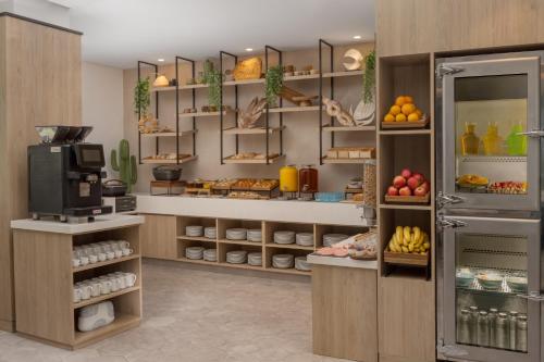 a kitchen with a bakery with fruits and vegetables at Staybridge Suites Dubai Business Bay by IHG in Dubai