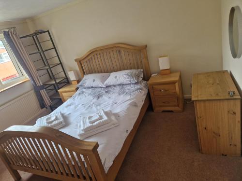 a bedroom with a wooden bed and a wooden dresser at 3 bedroom detached house centre of Whitchurch in Whitchurch