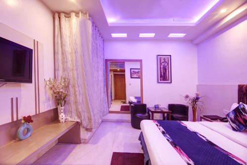 a hotel room with a bed and a tv at Hotel All Iz Well - Traveller Choice Award winner 2025 in New Delhi