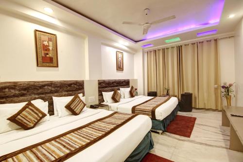 two beds in a hotel room with purple lights at Hotel All Iz Well - Traveller Choice Award winner 2025 in New Delhi