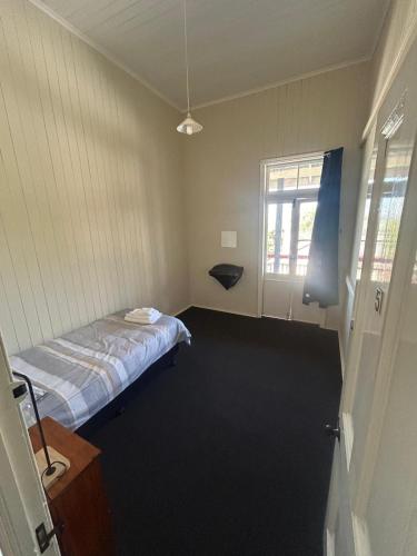 a hospital room with a bed and a window at Railway Hotel in Gympie