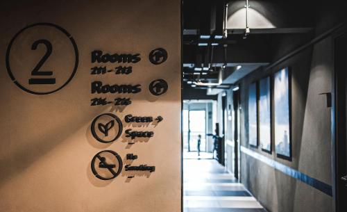 a hallway with signs on the wall in a building at THA City Loft by TH District in Bangkok