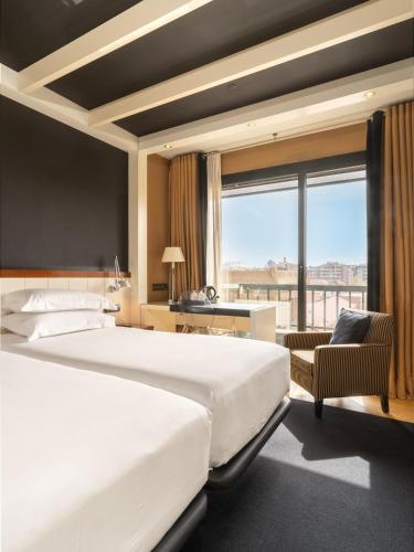 a hotel room with a large bed and a window at U232 Hotel in Barcelona