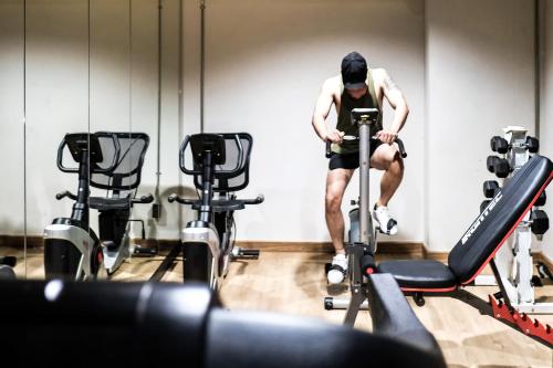 a man on a reformer in a gym at THA City Loft by TH District in Bangkok
