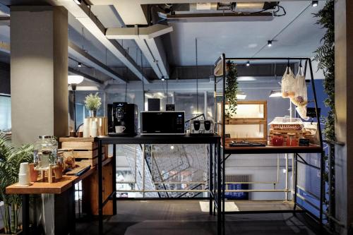 a room with two tables with microwaves on them at THA City Loft by TH District in Bangkok