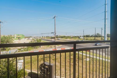 a balcony with a view of a street and a road at Blueground Lost Plains pool pet area wd ATX-271 in Austin