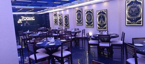 a restaurant with tables and chairs in a room at XCELSIOR HOTEL AND SPA by ROH in Shillong