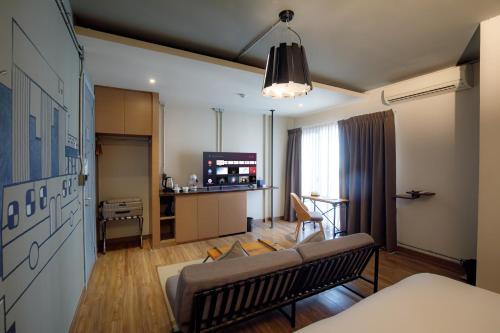 a living room with a couch and a table at THA City Loft by TH District in Bangkok
