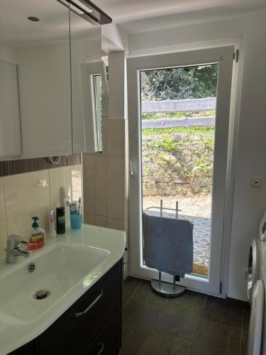 a kitchen with a sink and a large window at Elas Ferienhaus 66 in Freyung