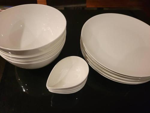 a group of white plates and bowls on a table at 小浜島 177号棟 in Kohama
