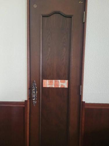 a wooden door with a sign on it in a room at 小浜島 177号棟 in Kohama