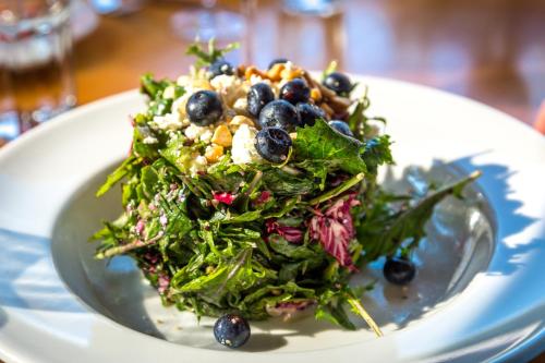 a salad on a white plate on a table at Evergreen Lodge at Yosemite in Groveland
