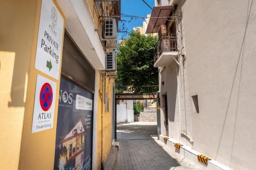 a narrow alley with a sign on the side of a building at Atlas Boutique Suites in Kavala