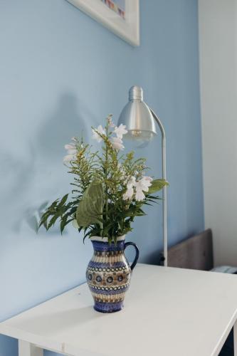 a vase with flowers in it sitting on a table at Dom w Dolinie in Trzcińsko
