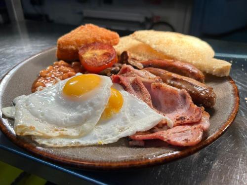 a plate of breakfast food with eggs bacon and toast at The Midland Hotel in Leeds