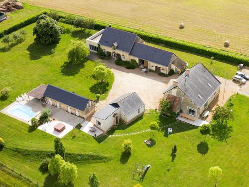 an aerial view of a large house with a yard at Closerie 3 étoiles La Poire à Loup, Domaine avec Piscine in Vaulandry