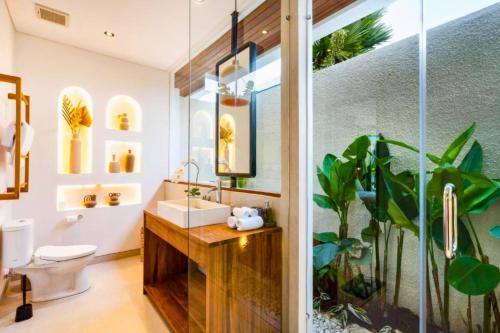 a bathroom with a sink and a mirror at Madaharsa 4 BR Private Pool Villa ZN203 in Ubud