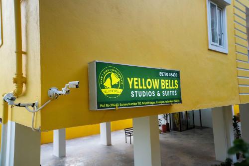 a yellow building with a yellow balls sign on it at Yellow Bells Studios And Suites in Gachibowli
