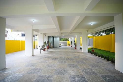 an empty hallway of a building with yellow walls at Yellow Bells Studios And Suites in Gachibowli