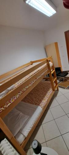 two bunk beds sitting on the floor in a room at Lunga Via Delle Dolomiti in Calalzo