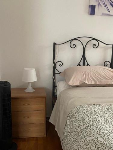 a bedroom with a bed and a table with a lamp at via Cappuccini 2b - soggiorna in centro a Gorizia con ascensore in Gorizia
