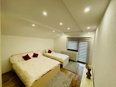 a small bedroom with two beds and a window at Apartman Admir in Gladno Polje