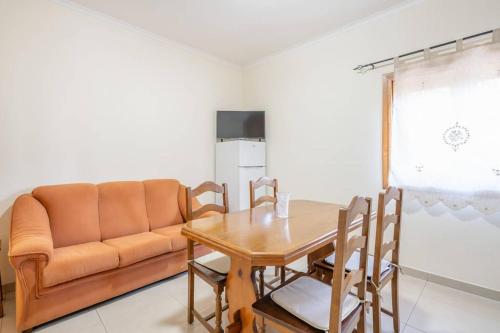 a living room with a table and a couch at Cantinho dos Fernandes II in Ponte da Barca
