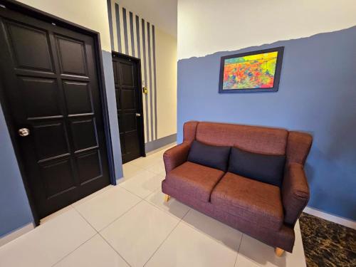 a living room with a couch and a black door at The Blue Guest House, WiFi, Free Parking, Aulong in Taiping