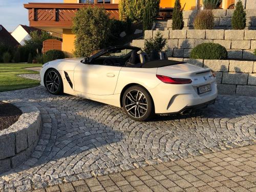 a white sports car parked in a driveway at FeWo - Im SCHWARZACHTAL in Neunburg vorm Wald