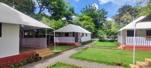 a person standing in a yard with a tent at Hiranya Nature Retreat in Daulatābād