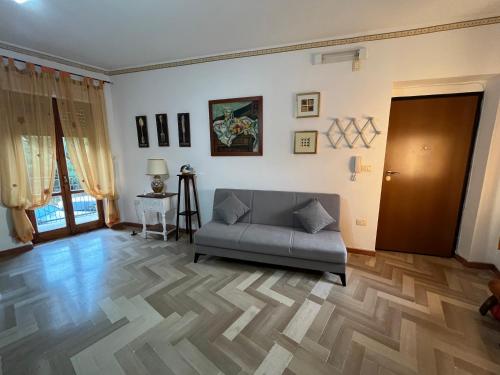 a living room with a couch and a wooden floor at Magic Living Home in Campora San Giovanni