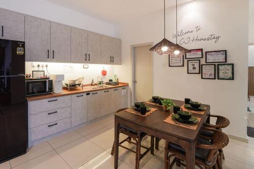 a kitchen with a table and a black refrigerator at Horizon Ipoh 8Pax 3R2B - Tropical Bali Retreat in Ipoh