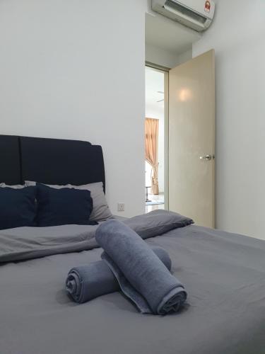 a bed with a stuffed animal on top of it at Southbay Seaview Condo A2 10minQueensbay 10minSpice in Bayan Lepas