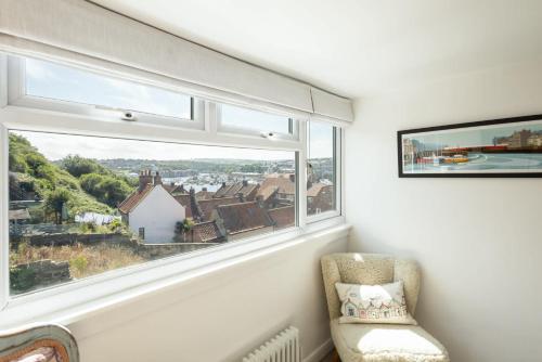 a chair in a room with a large window at Host & Stay - Voyagers' View in Whitby