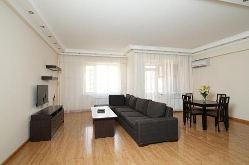 a living room with a couch and a table at Luxury 2-bedroom Apartments on 13 Buzand street by Sweet Home in Yerevan