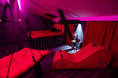 a room with a red room with two beds at Red Palace Apartament BDSM in Bydgoszcz