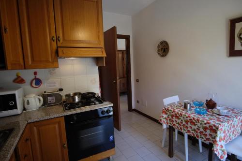 a kitchen with a table and a stove top oven at Zarina in Pallanza
