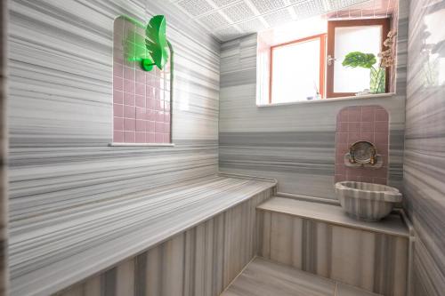 a bathroom with a tub and a sink at Delight Deluxe Port in Antalya