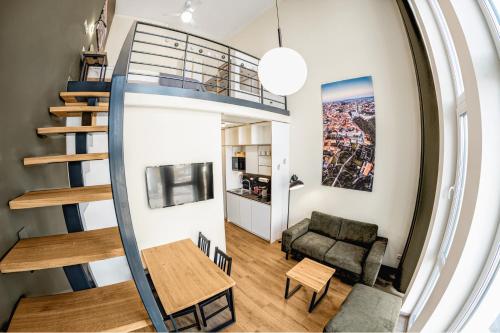 a room with a spiral staircase and a living room at TopFloor Apartments in Vilnius