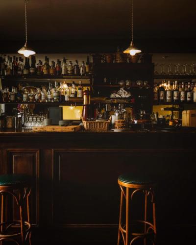 a bar with two bar stools in a room at Le Saint Hubert in Saint-Saturnin-les-Apt