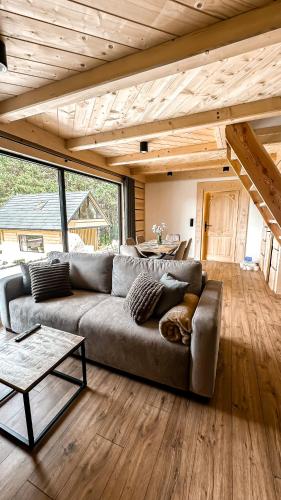 a living room with a couch and a table at Domki Trzy Szczyty in Daleszyce
