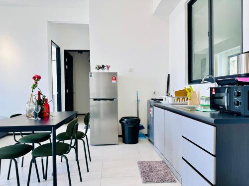 a kitchen with a table and a refrigerator at View of the whole Georgetown in George Town
