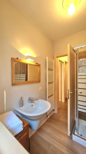a bathroom with a bath tub and a sink at Villetta 56 Blu Yellow and Red Lake view Garden Private Parking by Garda Domus Mea in Tremosine Sul Garda