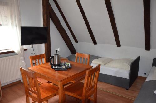 a dining room with a table and a bed at Zielony Dom in Bolesławiec