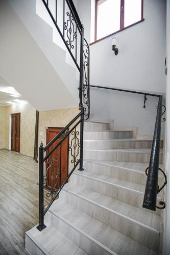 a staircase with metal railings in a house at თოია in Kvareli