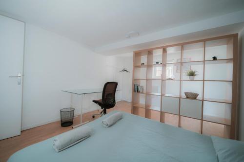 a bedroom with a bed and a glass wall at Le Domaine du petit Basque -20 pers in Talence