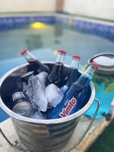 a bucket full of bottles of soda and ice at Little Green Farm in Wadi Musa